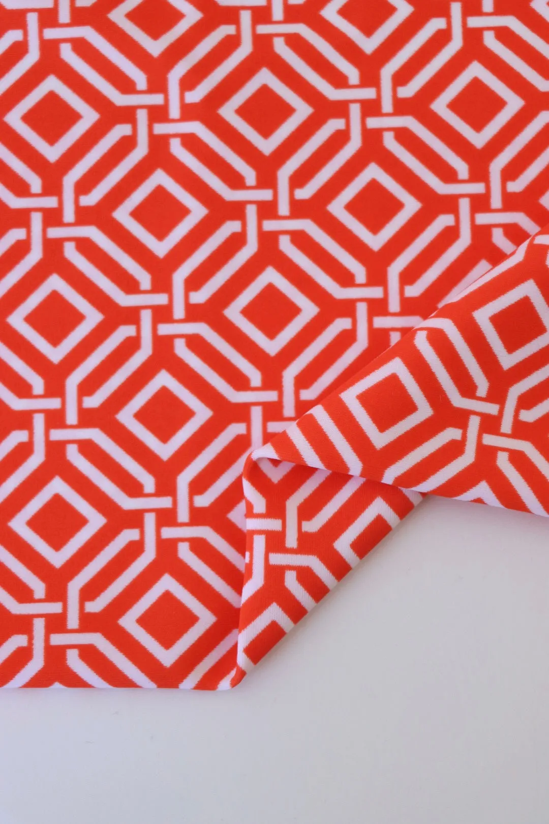 1YD PRECUT; Intertwined on Orange Nylon Spandex Tricot | Designer Deadstock